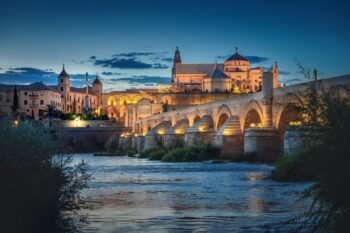 Cordoba Skyline At Night With Cathedral, Roman Bridge And San Rafael Triumphal Monument Cordoba, Andalusia, Spain