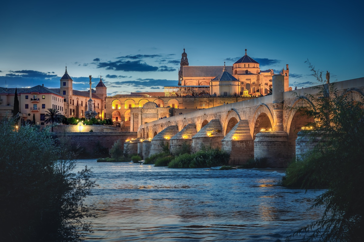 Cordoba Skyline At Night With Cathedral, Roman Bridge And San Rafael Triumphal Monument Cordoba, Andalusia, Spain