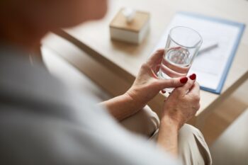 Therapy Patient Holding Glass Of Water