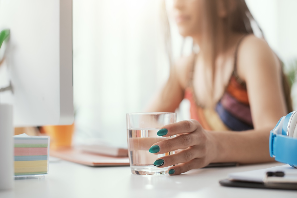 Woman Drinking Water At Home